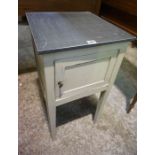 An Antique French Painted Pine Bedside Cabinet, Having a panelled door, areas of old worm to base,