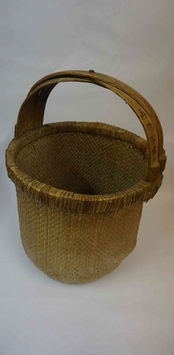 A Chinese Style Woven Rice Basket, Having character marks to the handle, 62cm high