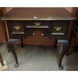 A Georgian Oak Lowboy, Having a single drawer, flanked with a deeper drawer, raised on cabriole legs