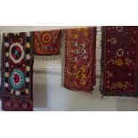 Four Old Suzani Embroidered on Silk Throws, Decorated with assorted floral and geometric panels,