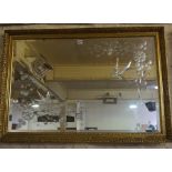 A Modern Gilt Framed Wall Mirror, Decorated with etched floral panels to the glass, 72cm high, 102cm