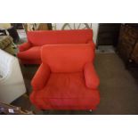 A Red Upholstered Two Seater Sofa, 80cm high, 202cm wide, also with a matching armchair, raised on