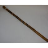 A Chinese Bamboo Walking Stick, The shaft carved with snakes, character marks below, 90cm long