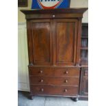 A Victorian Mahogany Linen Press on Chest, Having two panelled doors, enclosing four long drawers,