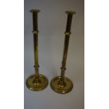 A Pair of Brass Lever Action Candlesticks, circa 19th century, of tall form, raised on a knopped