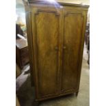 A Louis Phillipe Style Mahogany Wardrobe, Having two panelled doors, enclosing a fitted shelve and