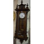 A Walnut Cased Vienna Wall Clock, circa early 20th century, having mask decration, white enamel dial