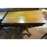 A Victorian Mahogany Tea Table, Having a swivel fold over top, raised on a baluster column and