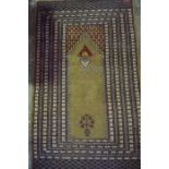 A Pakistani Prayer Rug, Having geometric motifs, on a beige ground, 158cm x 96cm