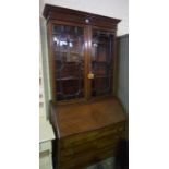 A Mahogany Bureau Bookcase, Having two glazed astragal doors, enclosing a shelved interior, above