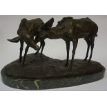 A Patinated Bronze Figure Group of Two Cows, raised on a green marble effect plinth base, 22cm high,