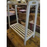 A White Painted Towel Rail, 76cm high, 61cm wide, also with a white painted stool, areas of old worm