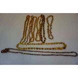 Seven Strings of Costume Amber Coloured Bead Necklaces, Various sizes, (7)