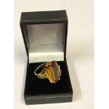 A Fine 18ct Yellow Gold and Synthetic Yellow Sapphire Ring, the emerald cut stone is approximately