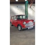 A 1995 Mini Sprite 1275cc, Red with a white roof. 77,590 miles, MOT April 2020. Drives and looks
