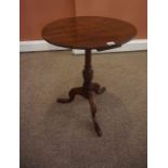 A Georgian Mahogany Tea Table, the circular top is raised on a turned baluster column and tripod