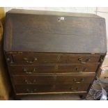 A Georgian Oak Writing Bureau, Having a fall front enclosing fitted drawers and pigeon holes,