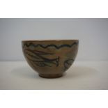 Studio Pottery Bowl, circa 1960s, Decorated with allover panels of fish on a glazed brown ground,