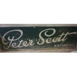 A Large Painted Shop Advertising Sign, for Peter Scott Knitwear, having white painted letters on a