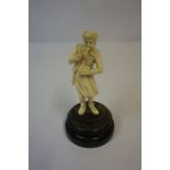 Antique Carved Ivory Figure of a Snuff Taker, 10cm high, raised on a fixed ebonised stand