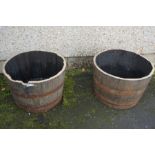 A Pair of Whisky Half Metal Bound Barrels, Used as planters, 44cm high, 64cm wide, (2)