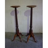 A Pair of Mahogany Torchere, Having an octagonal top, raised on a reeded, turned column and