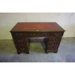 Reproduction Kneehole Desk, Having a tooled red leather skiver above three assorted drawers,