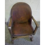 Hide Upholstered Armchair, circa 1920s-30s, Having a stamped Heraldic crest to back rest, with