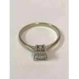 A Four Stone Ring, Square cut setting, white metal shank