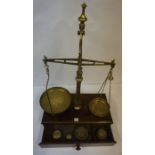 Set of Avery Brass Balance Scales, raised on a mahogany pedestal base, complete with weights