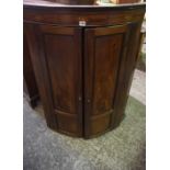 Georgian Mahogany Corner Cupboard, Having two doors enclosing a shelved interior,