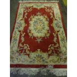 Chinese Style Rug, Decorated with floral panels on a red ground,