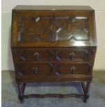 Jacobean Revival Oak Writing Bureau, Having a fall front enclosing drawers and pigeon holes, above