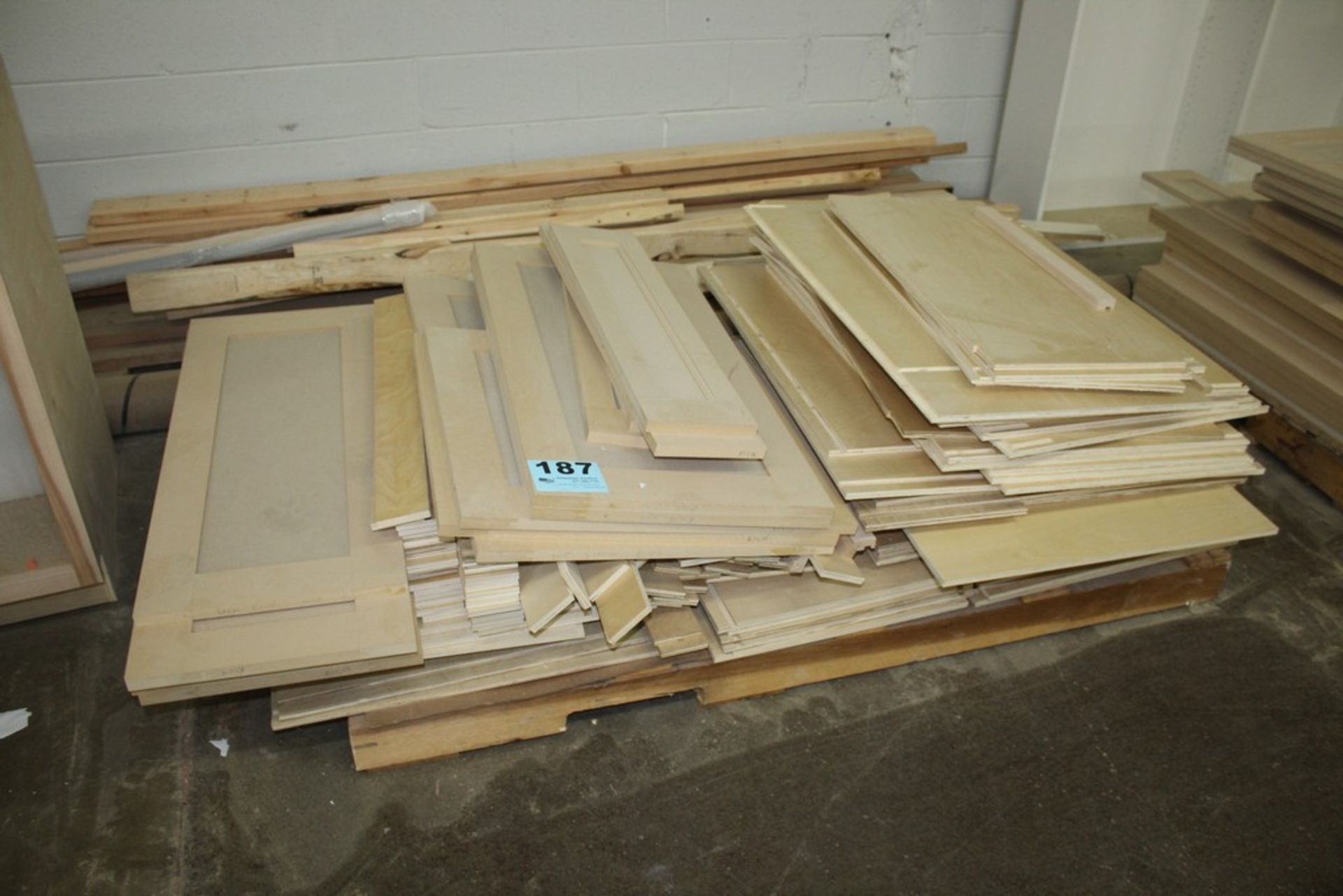 ASSORTED WOOD PANELS AND LUMBER ON SKID