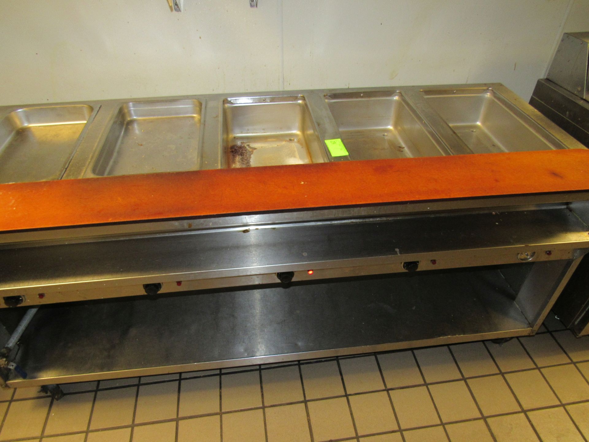 Five-compartment electric steam table with cutting board and under shelf, on casters, length 78"