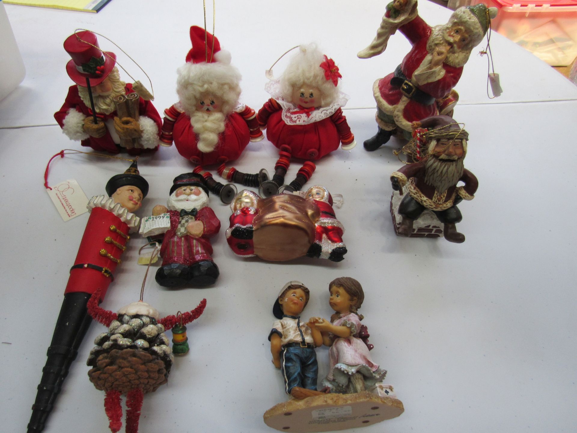 Group of Christmas ornaments: Santa Clauses, baseball boy and girl, etc.