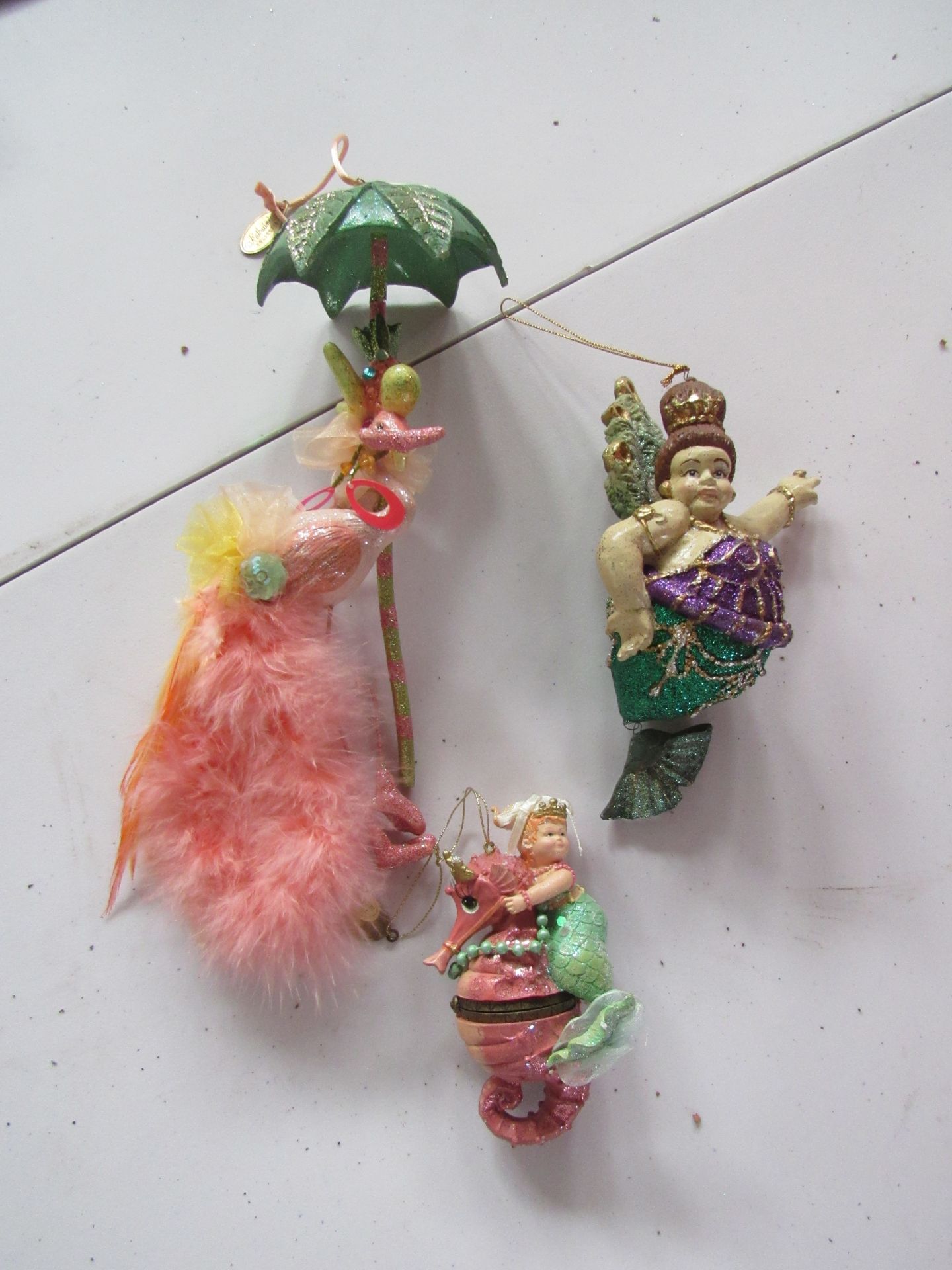 Group of Katherine's Collection ornaments: flamingos and mermaids