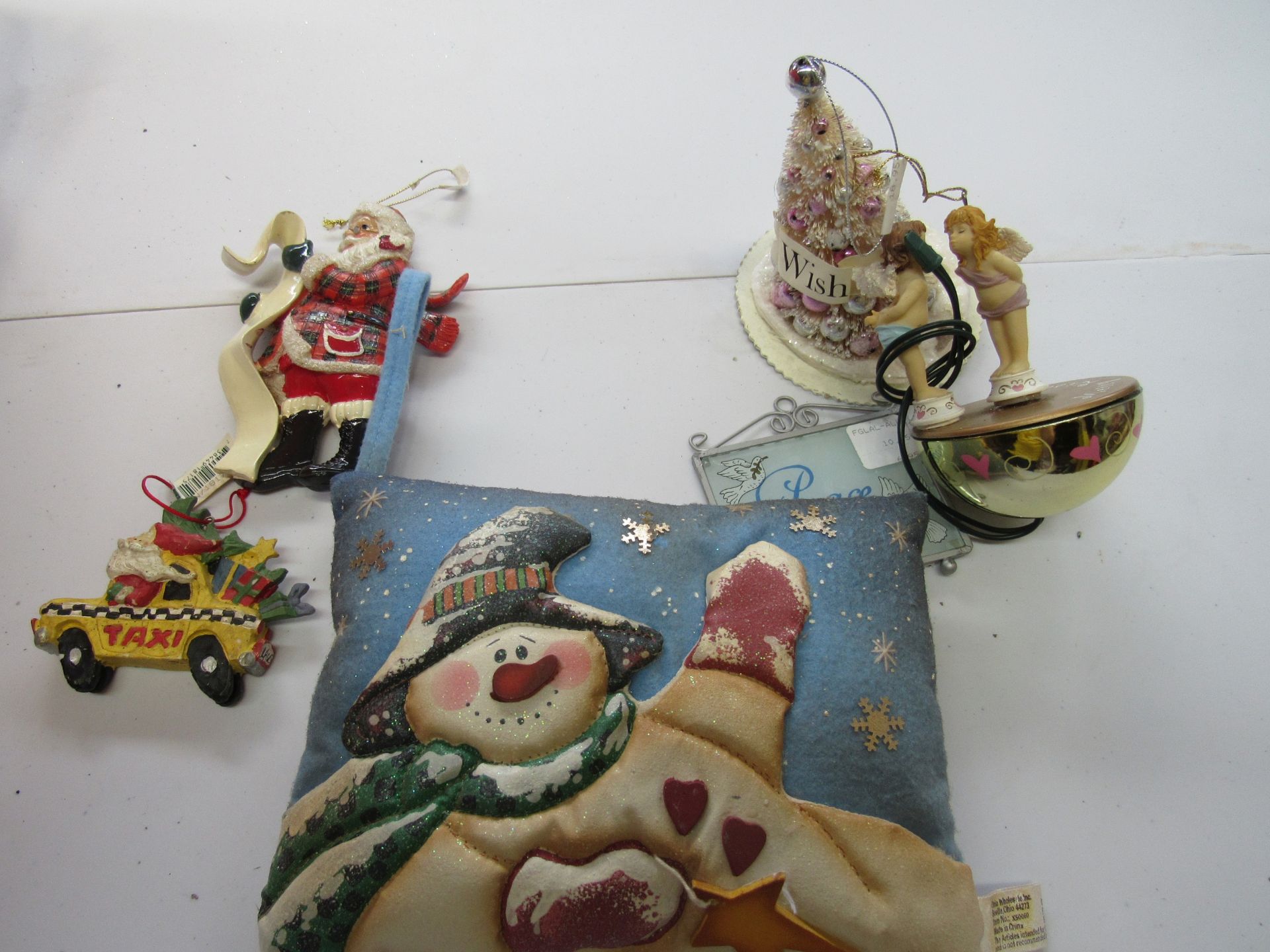 Group of assorted Christmas items: motorized ornament, snowman pillow, etc.