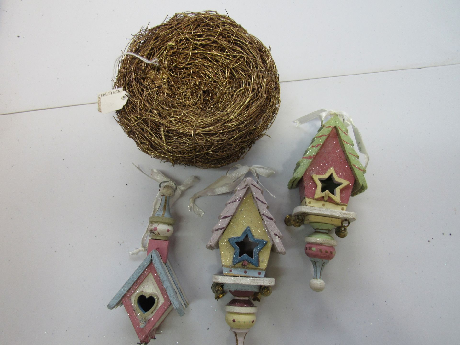 Group of pastel birdhouse ornaments with nest