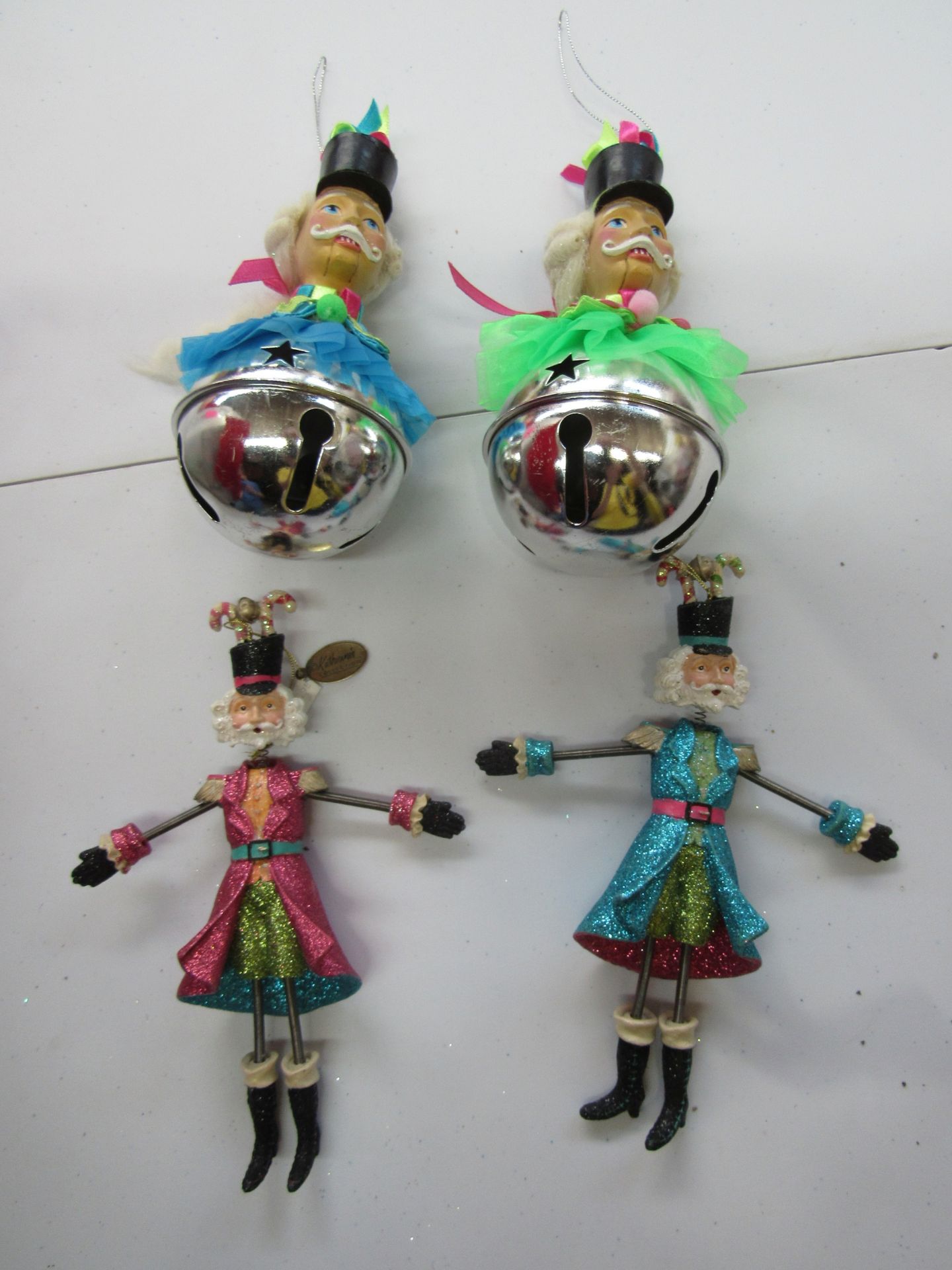 Group of Katherine's Collection Christmas ornaments: nutcracker with bells and Santa