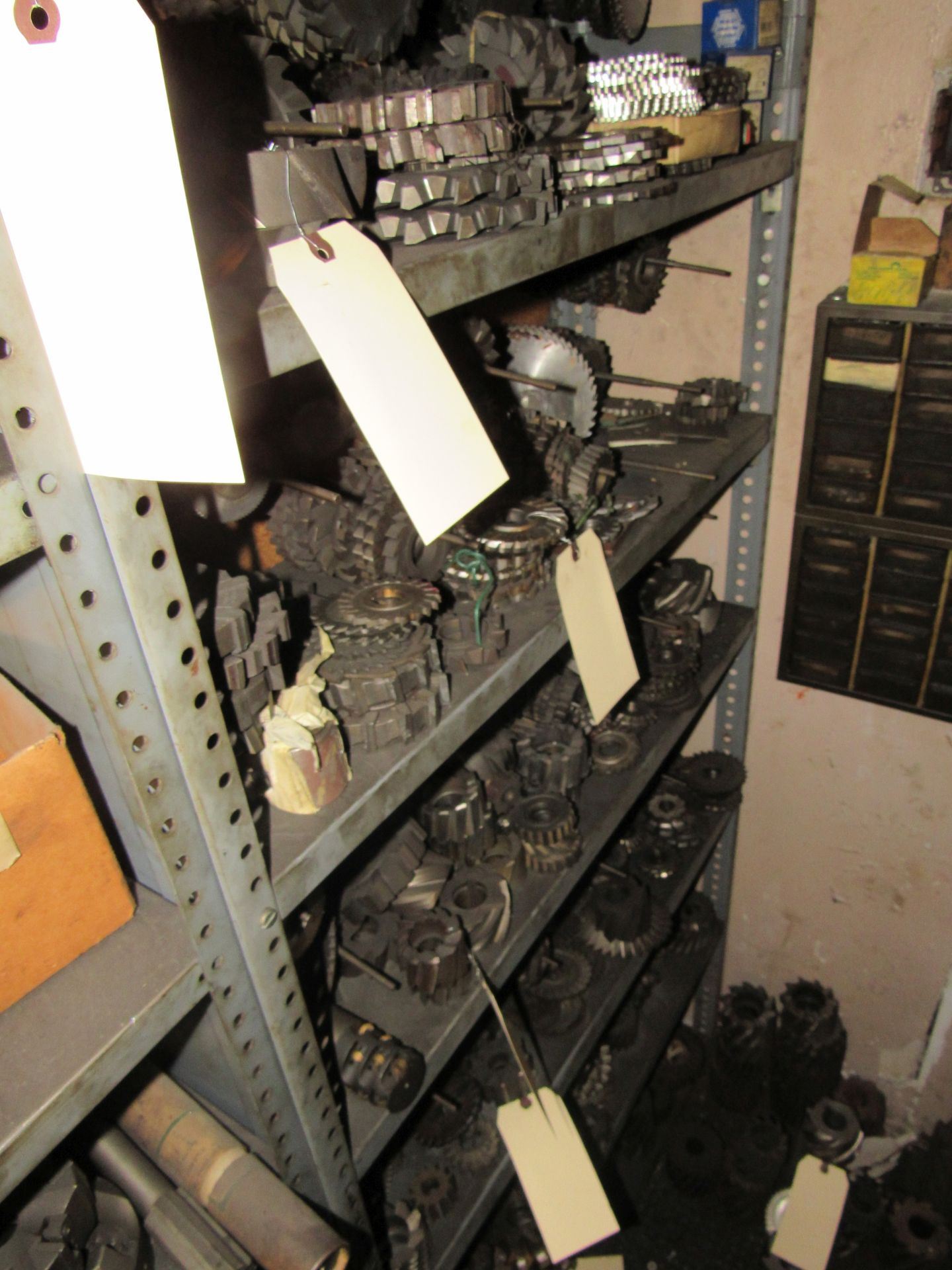 Contents of shelf with miscellaneous cutting wheels and cutting wheels on floor