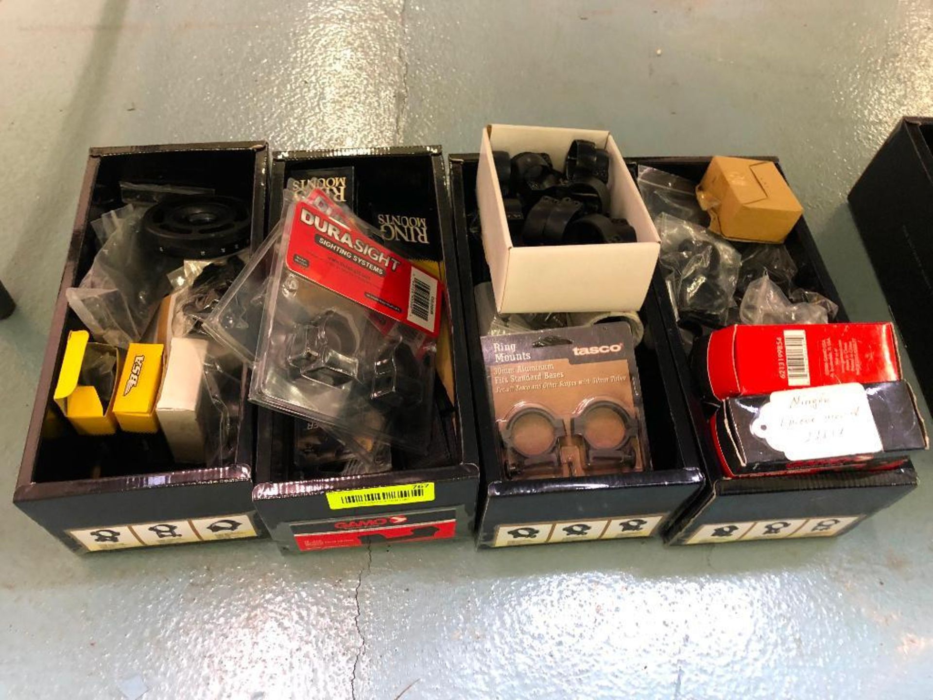 DESCRIPTION: (4) BOXES OF ASSORTED SCOPE MOUNTED HARDWARE. LOCATION: BACK BAY THIS LOT IS: ONE MONEY