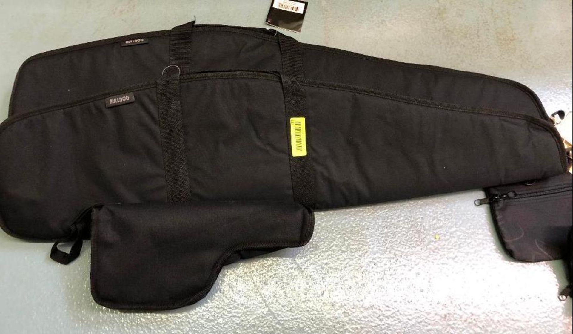 DESCRIPTION: (2) BLACK CANVAS RIFLE BAGS W/ (1) PISTOL CASE. LOCATION: BACK BAY THIS LOT IS: ONE MON