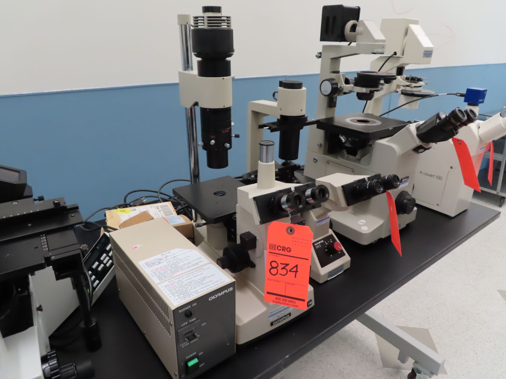 Olympus IM stero zoom microscope with light source and Olympus burner unit, located B wing, 3rd