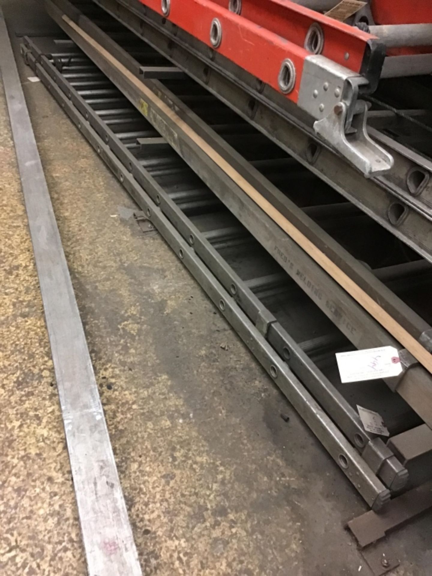 Aluminum extension ladder on floor