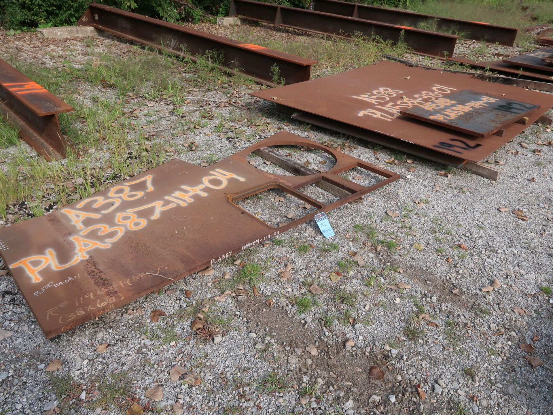 (LOT) MISC. STEEL PLATE ON GROUND W/ MISC. SCRAP STEEL AT END OF ROW (BLACK PAINT)