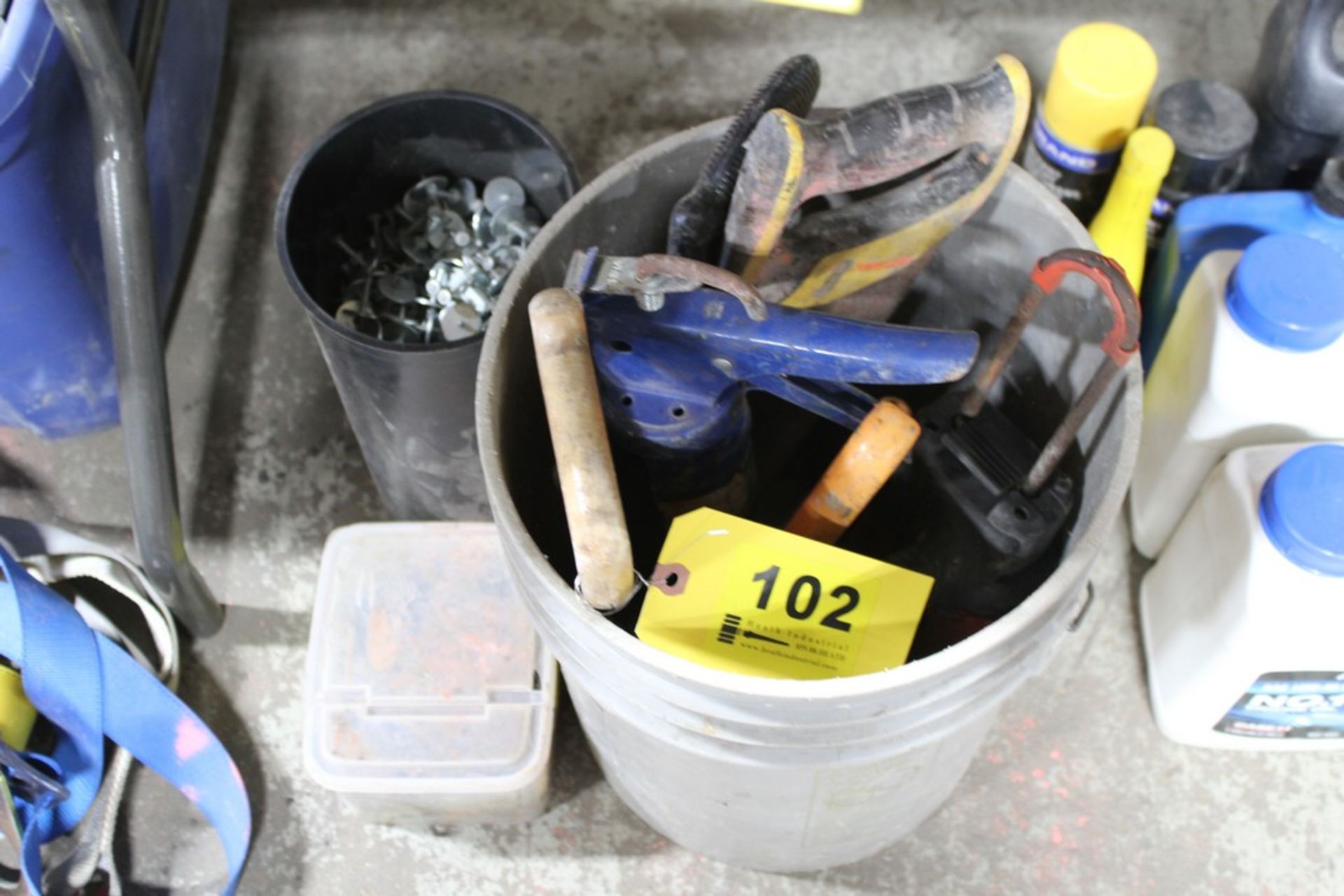 ASSORTED SAWS AND CAULK GUNS IN BUCKET