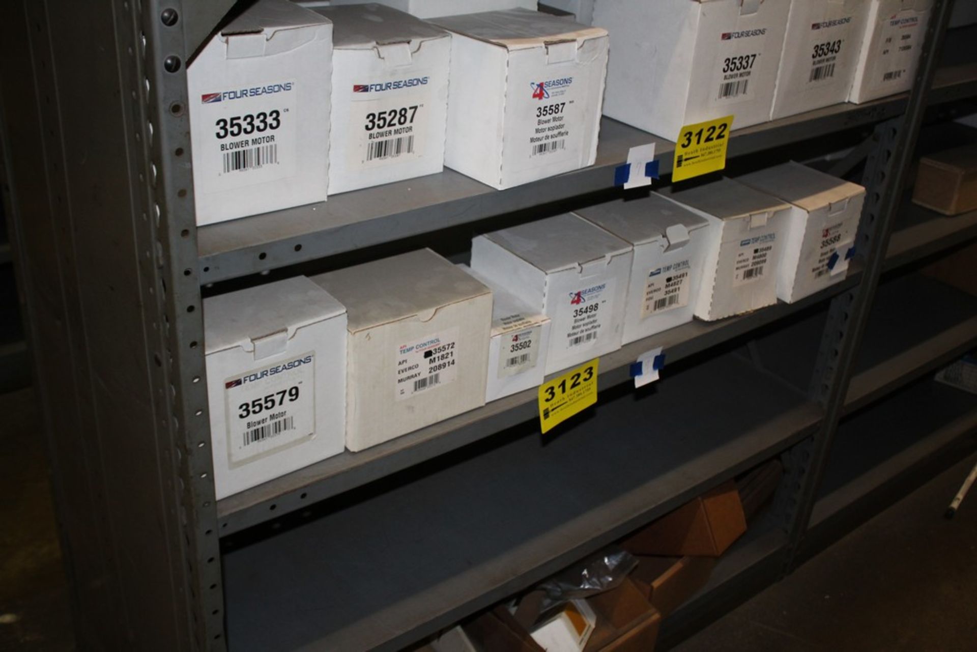 ASSORTED FOUR SEASON BLOWER MOTORS ON SHELF