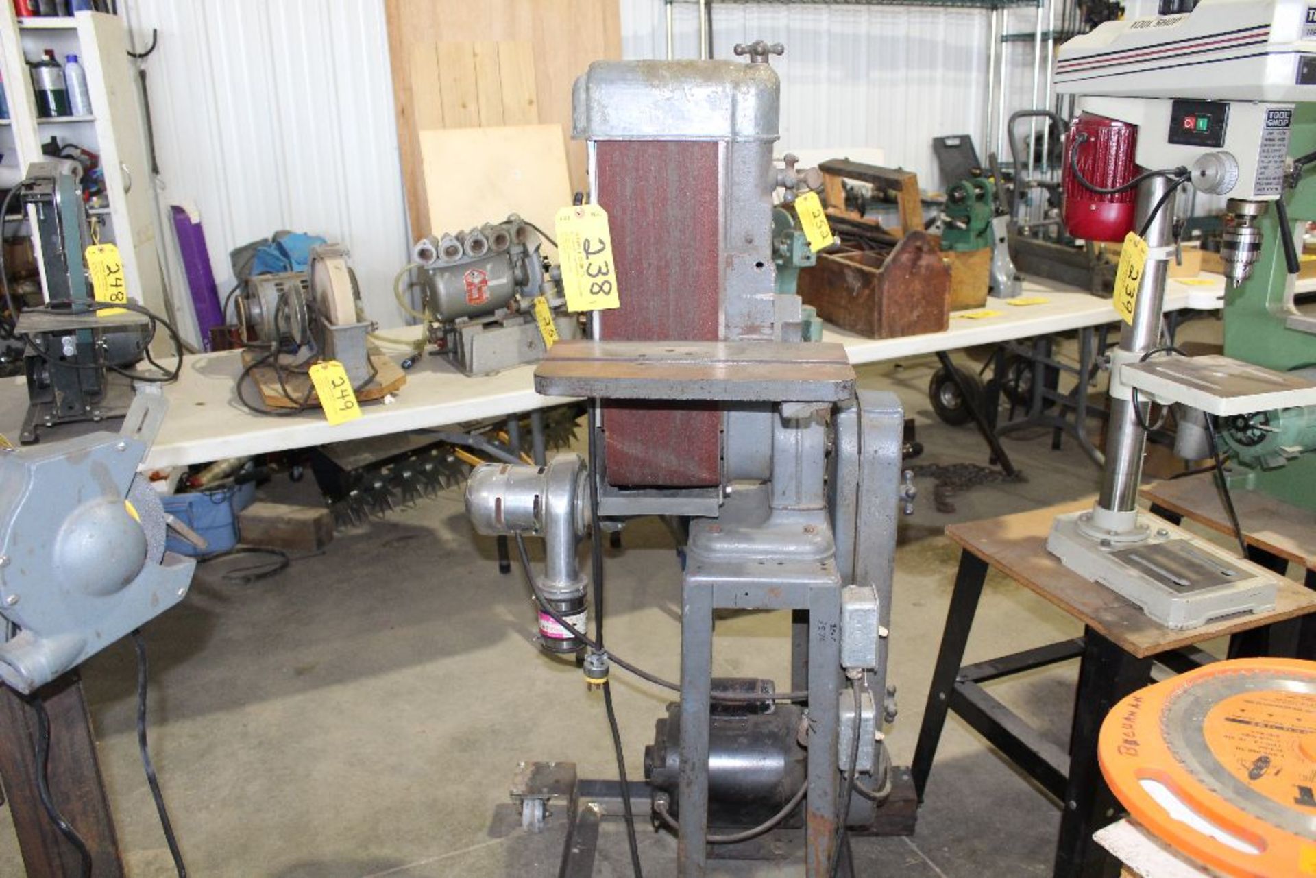 Vertical belt sander, 6", 3/4 hp, w/vacuum atachment on roller stand.