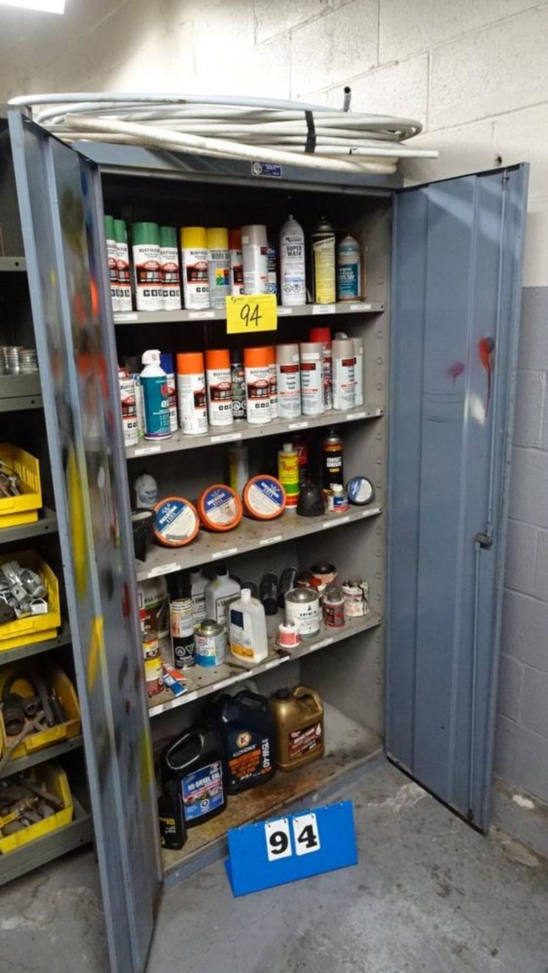 TWO DOOR STORAGE CABINET C/W ASSORTED PAINT, LUBRICANTS ETC. (RIGGING FEE $25)